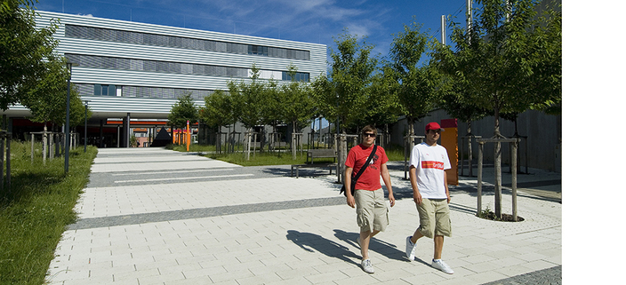 Zwei Personen vor dem Campusgelände Zwei Personen vor dem Campusgelände
