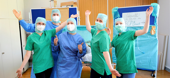 Mitarbeitenden der Kliniken Ostalb posieren in OP-Kitteln vor der Kamera Mitarbeitenden der Kliniken Ostalb posieren in OP-Kitteln vor der Kamera